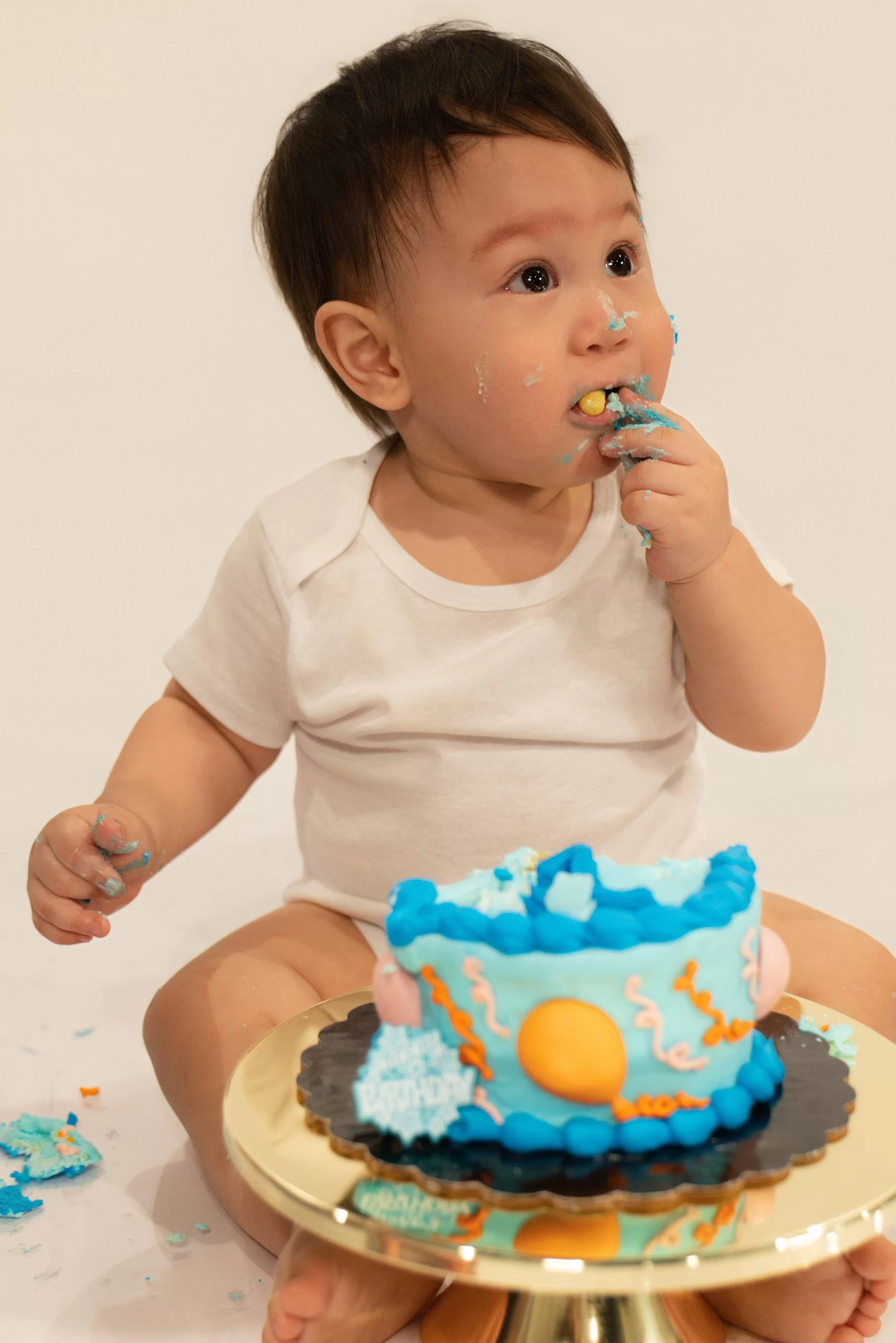 Baby Jet eating a cake healthy and happy after receiving his donor milk