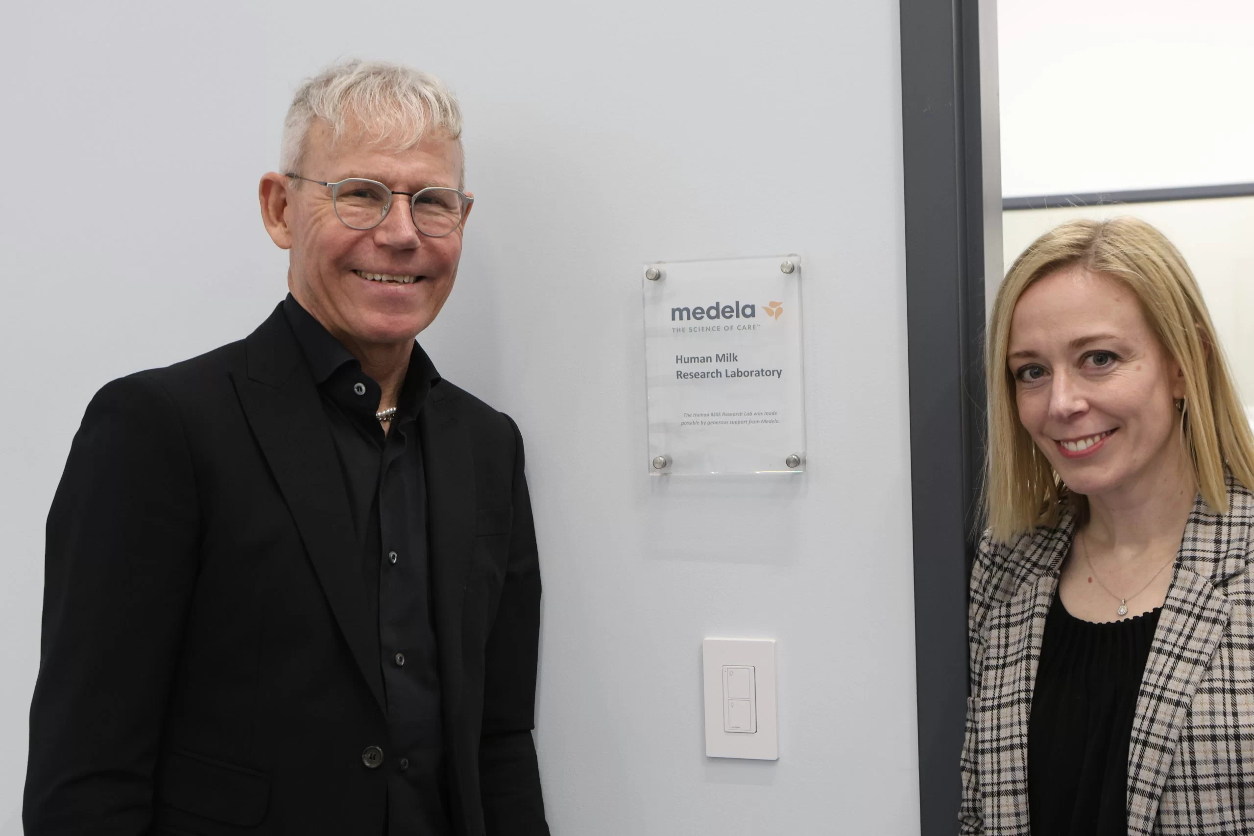 Michael Larsson Medela Chairman of the Board and Summer Kelly Executive Director of Mothers' Milk Bank of the Western Great Lakes Celebrating the Medela Research Lab