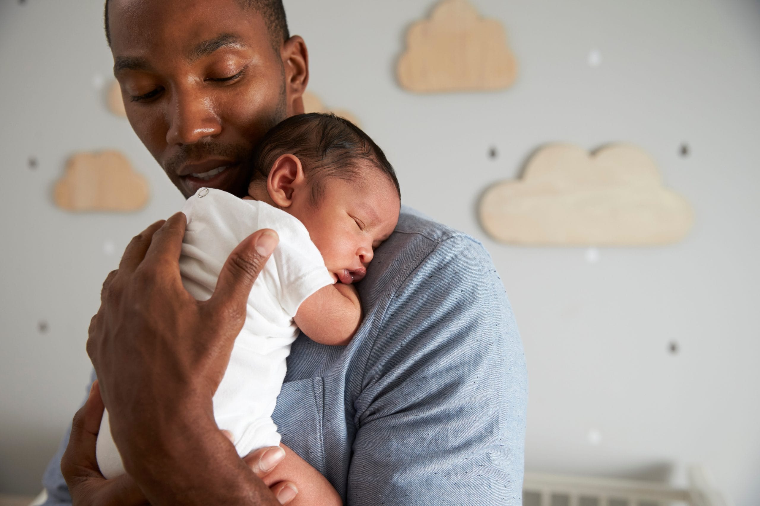 father holding newborn to chest